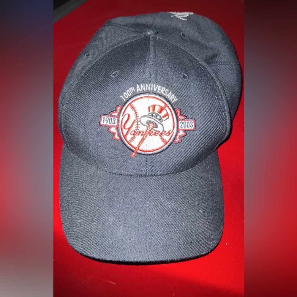 New York Yankees baseball hat.